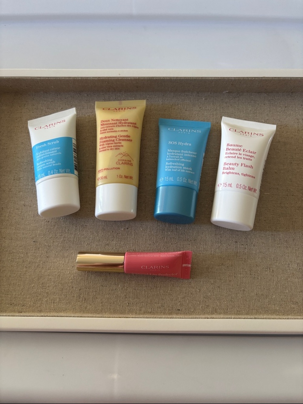 Clarins skincare mini set in blue, cream, white & pink